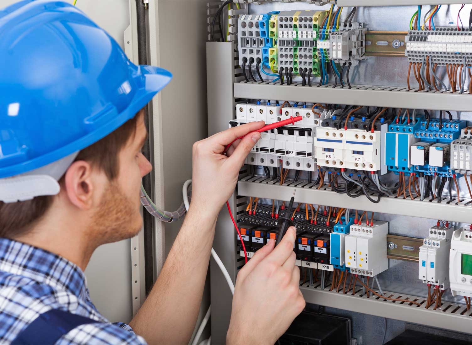MESI automation and electrical engineering technician working on control panels